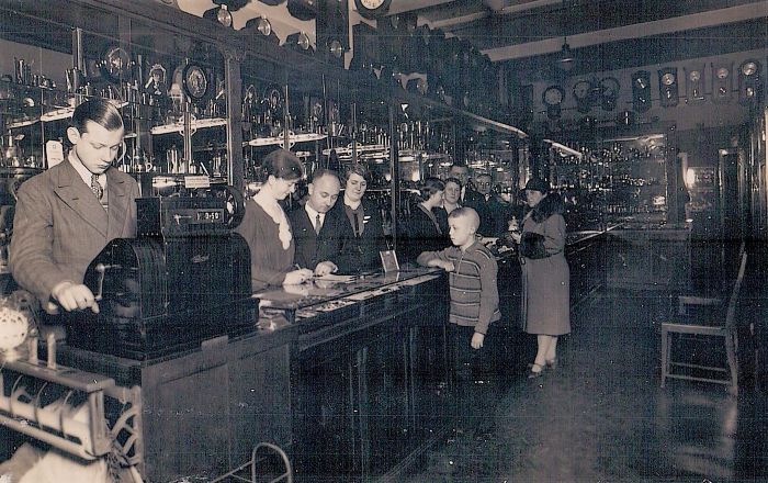 Friedrich Wilhelm Rather at the cash register inside the historic Rather family clock shop in Harburg.