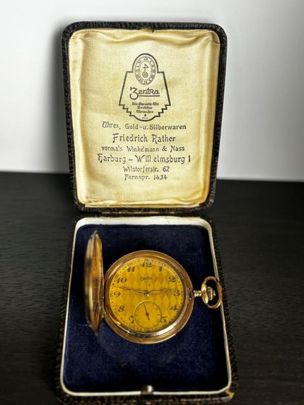 A ZentRa gold pocket watch in its original display case from the historic Friedrich Rather clock shop portfolio.
