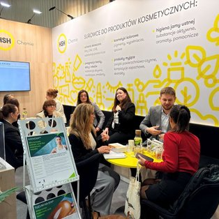 Visitors discuss cosmetic raw material samples at HSH Chemie’s booth at PCI Days 2026.